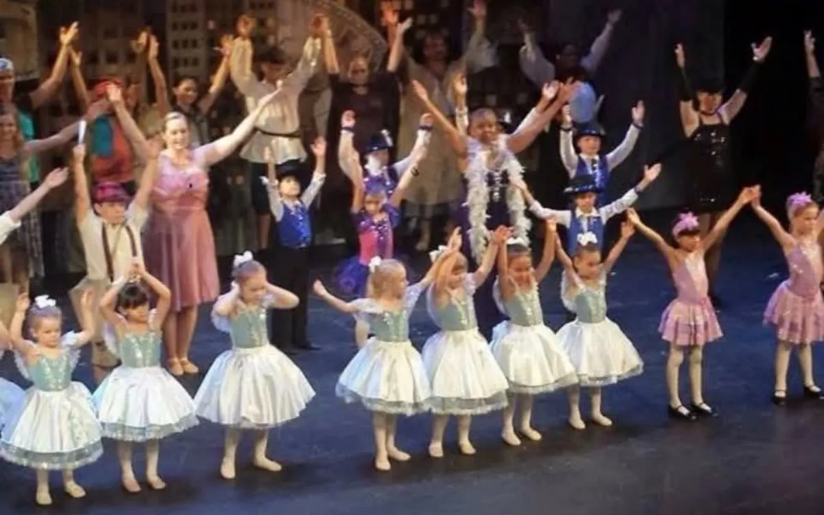 Dancers of all ages on stage at a recital